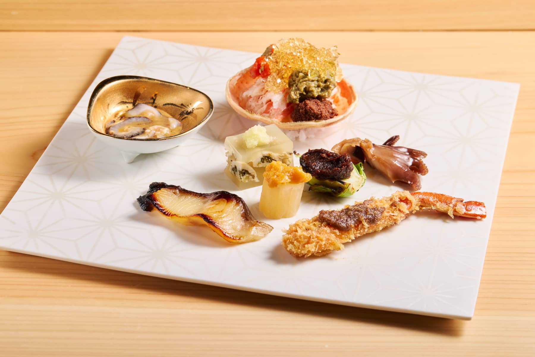 simmered baby octopus,oyster aspic,deep-fried snow crab with anchovy sauce,Brussel sprouts glazed with miso,sablefish glazed with saikyo miso,Black taro with sweet miso sauce,sea cucumber with salted entrails